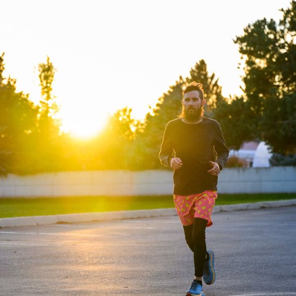 Silhouette of a person stretching during sunrise, symbolizing energy and vitality.